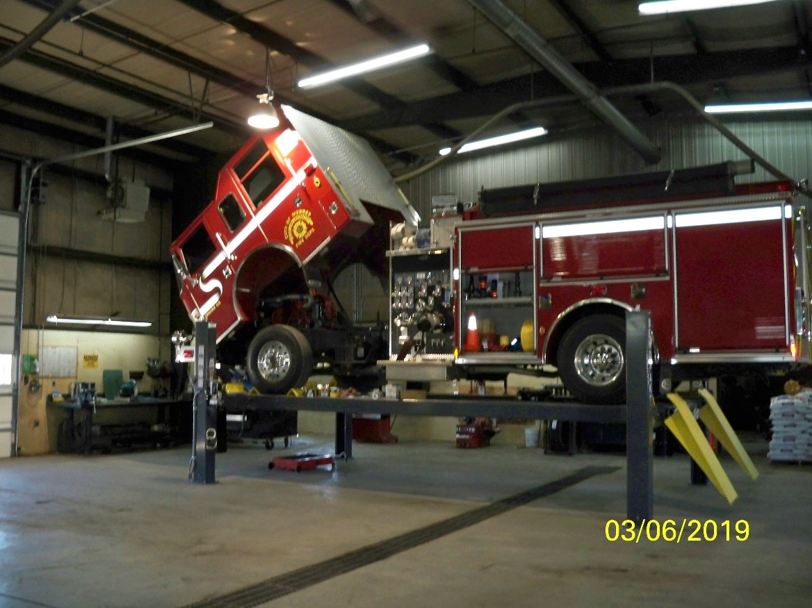 Fire Truck on a lift being worked on